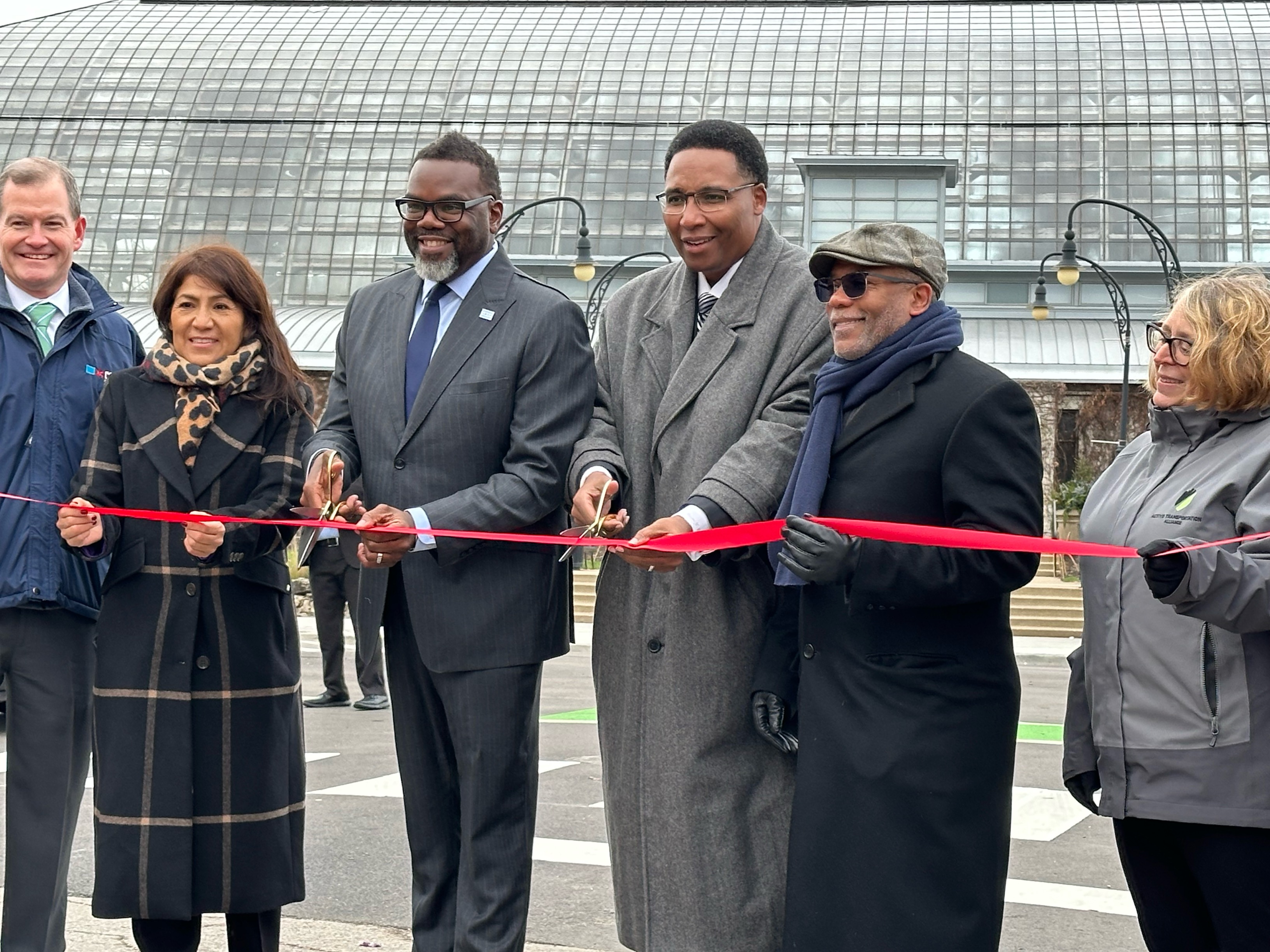 Mayor Johnson and other city officials and community leaders stand with a ribbon and scissors for a ceremonial ribbon cutting on Central Park Avenue